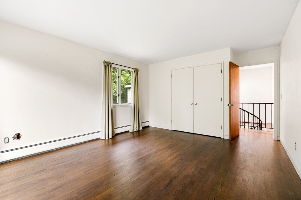 91 Weston Road Lincoln, MA 01773 - Photo 24 of 34 an empty room with wooden floor and windows