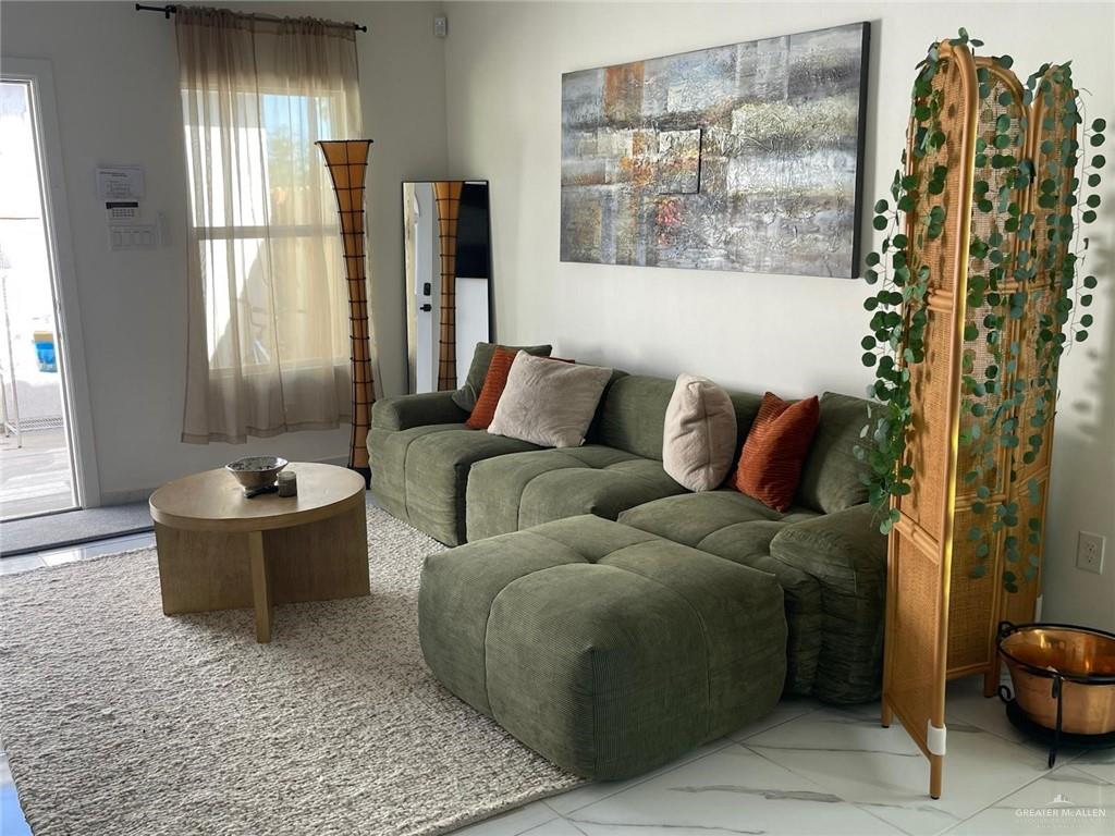 607 Buccaneer Drive, Unit 4 Hidalgo, TX 78557 - Photo 2 of 9 a living room with furniture and a large window