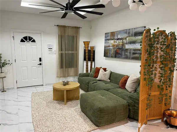 a living room with furniture and flat screen tv