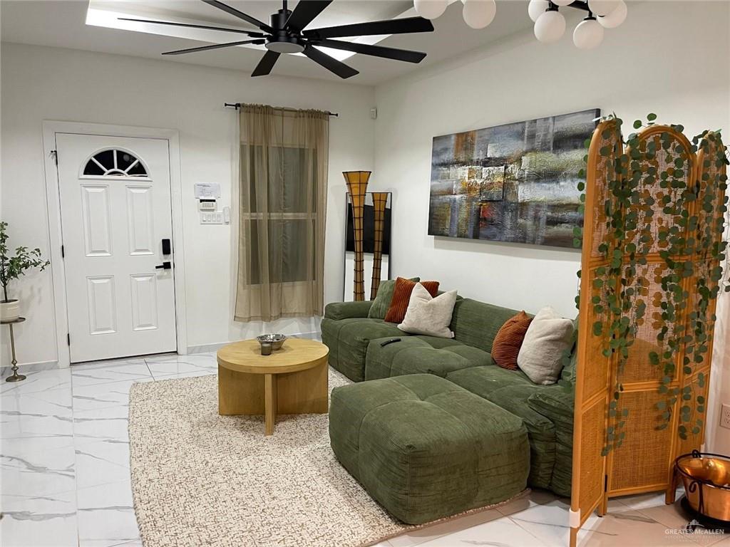 607 Buccaneer Drive, Unit 4 Hidalgo, TX 78557 - Photo 3 of 9 a living room with furniture and flat screen tv