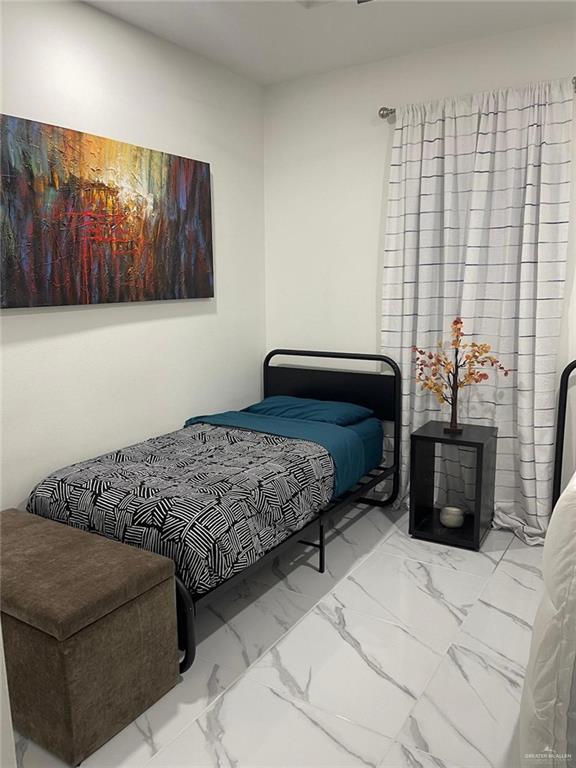 607 Buccaneer Drive, Unit 4 Hidalgo, TX 78557 - Photo 5 of 9 a bedroom with a bed couch and a window