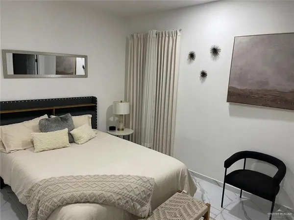 a bedroom with a bed and chair