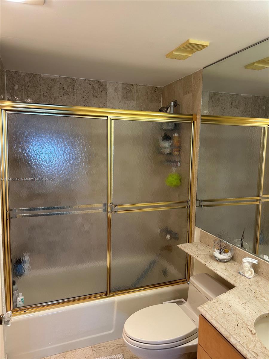 Miami-Dade County Miami, FL 33181 - Photo 14 of 19 a bathroom with a granite countertop sink toilet and shower