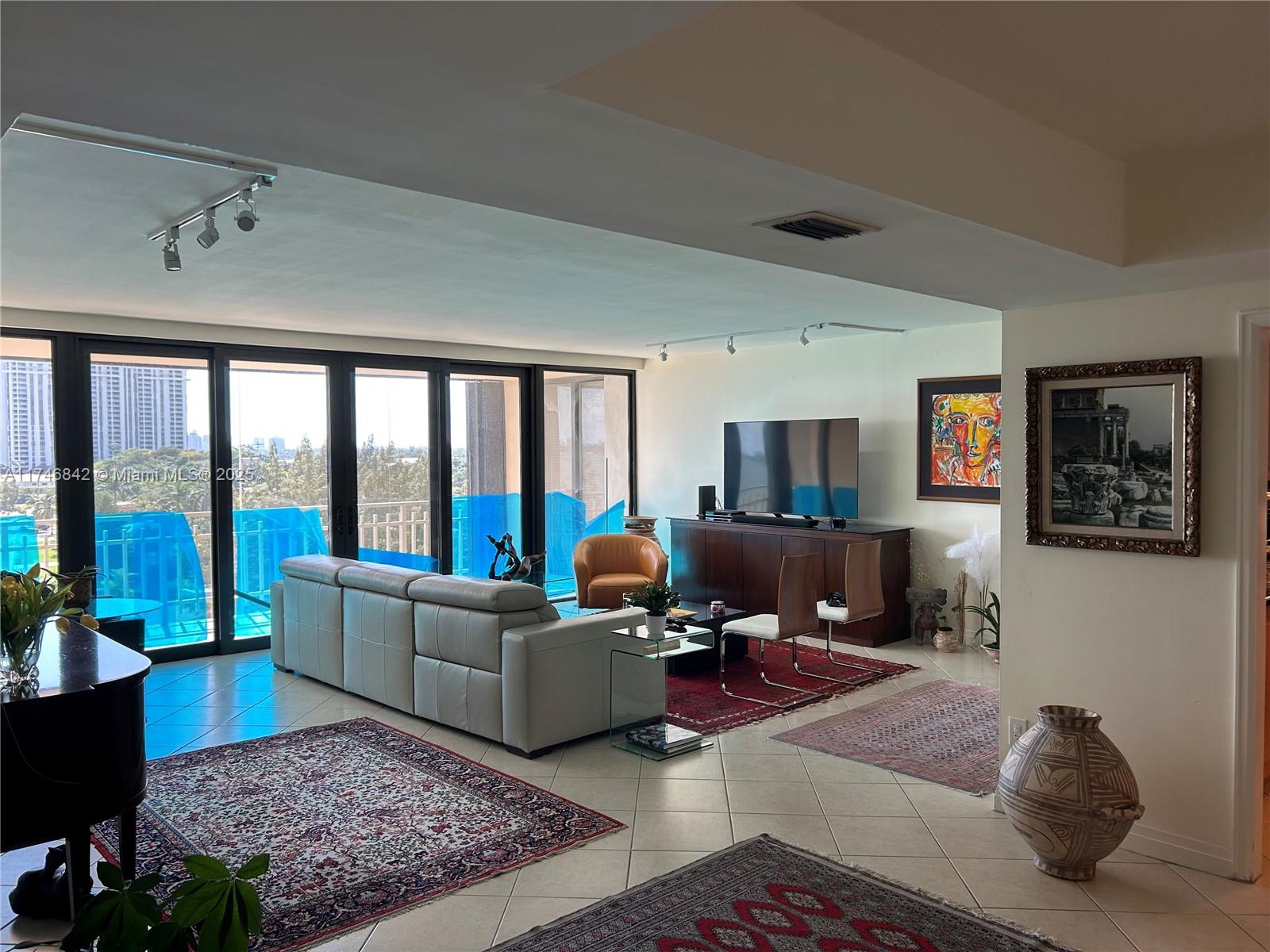 Miami-Dade County Miami, FL 33181 - Photo 5 of 19 a living room with furniture and a flat screen tv