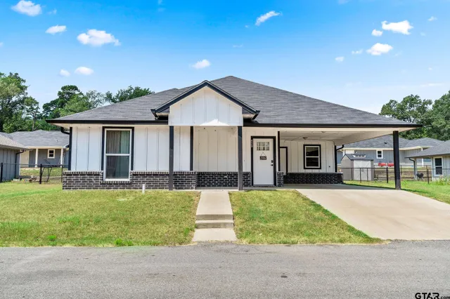 a front view of a house with a yard and porch