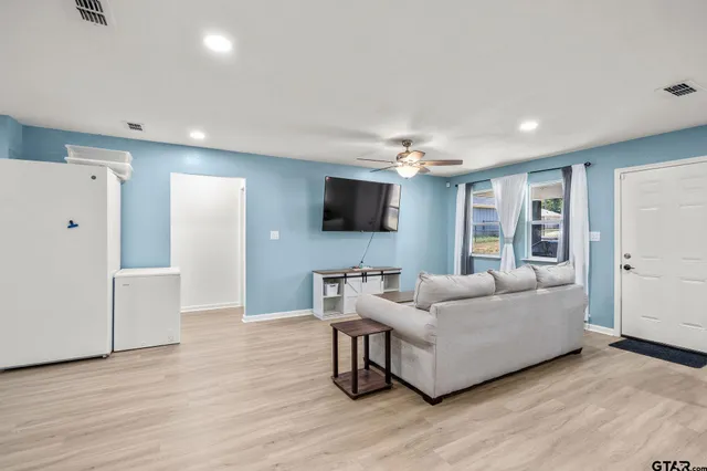 a living room with furniture and a flat screen tv