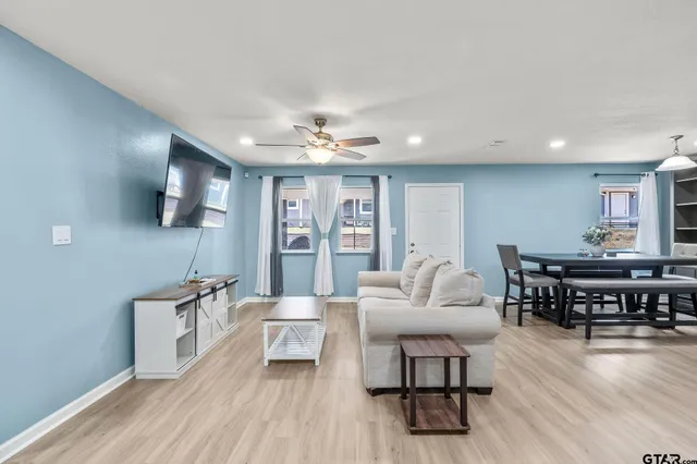 a living room with furniture and wooden floor