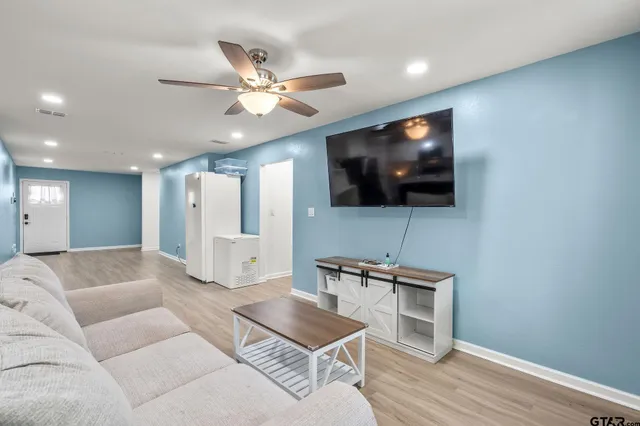 a living room with furniture and a flat screen tv