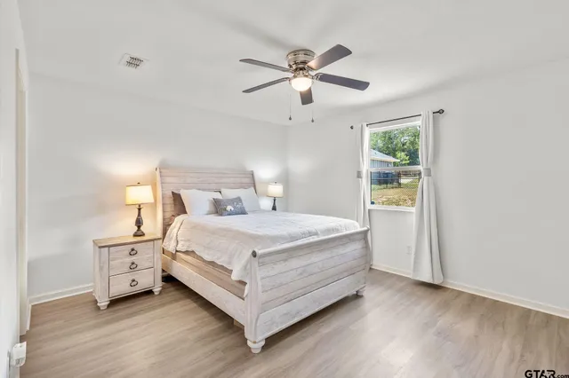 a bedroom with a bed and a chandelier