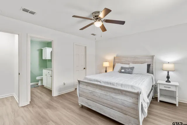 a bedroom with a bed and a chandelier