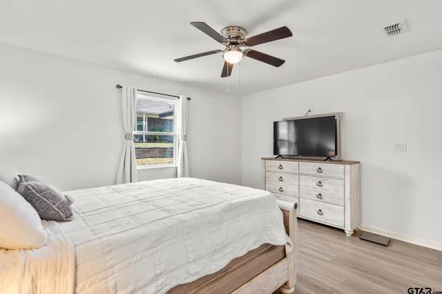 a bedroom with a bed and a flat screen tv
