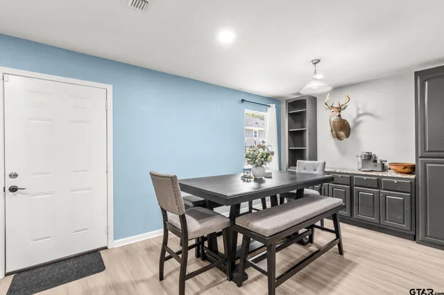 a view of a dining room with furniture and wooden floor