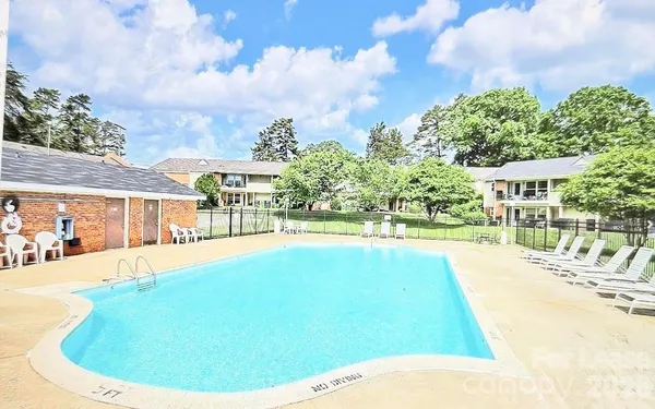 a view of a swimming pool with an outdoor seating area