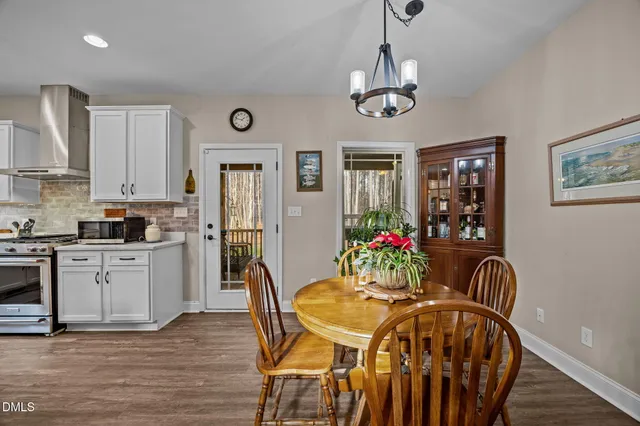 a view of a dining room with furniture and wooden floor