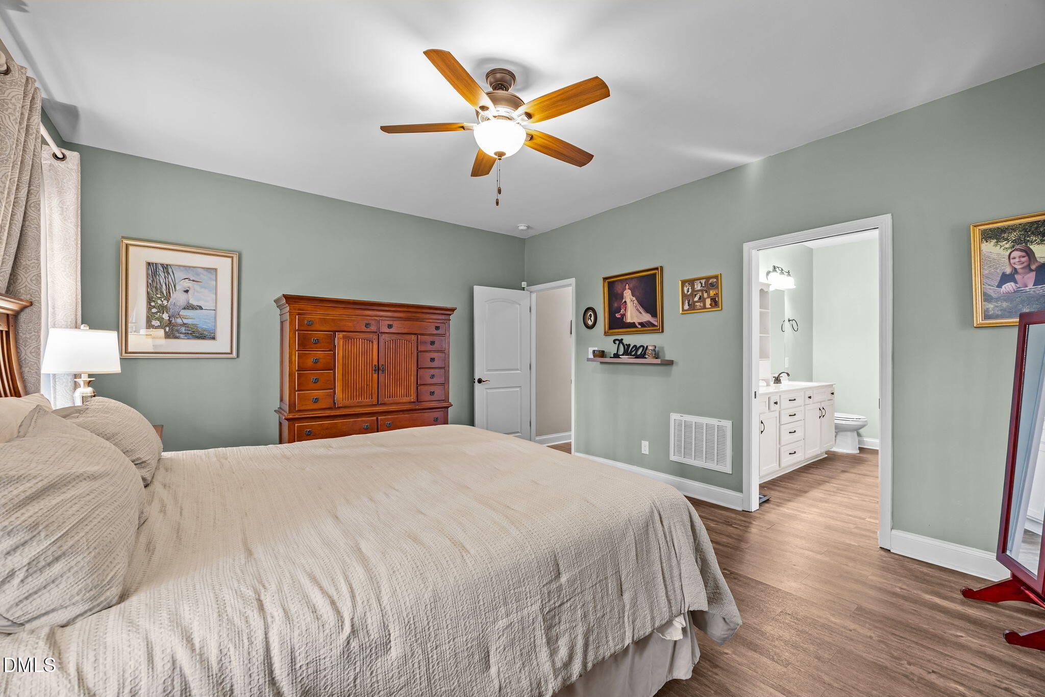 3225 Back Acres Road Efland, NC 27243 - Photo 14 of 57 a bedroom with a large bed a large window and a chandelier