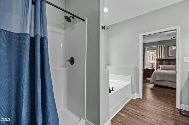 a bathroom with a tub and a hallway