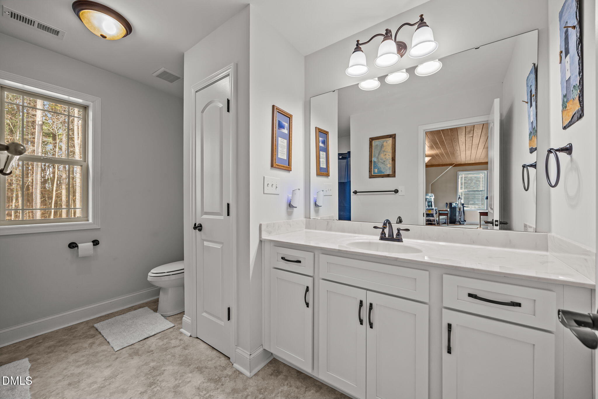 3225 Back Acres Road Efland, NC 27243 - Photo 21 of 57 a spacious bathroom with double sink a toilet a window and a mirror