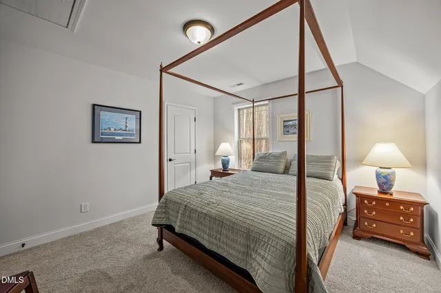 a bedroom with a bed and a lamp