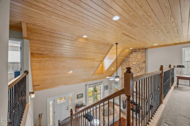 a view of staircase with railing and white walls
