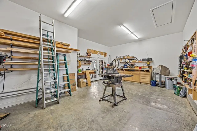 a view of a patio with table and chairs with wooden floor and fence