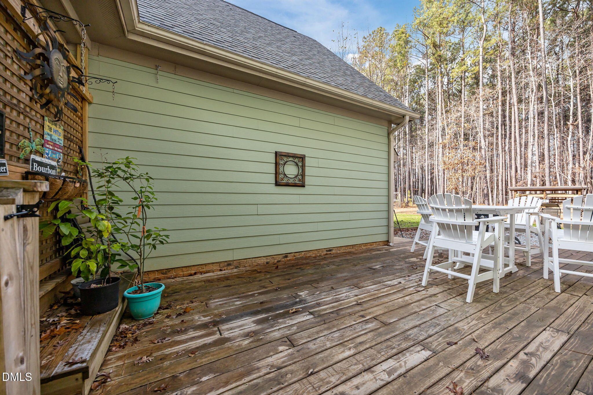 3225 Back Acres Road Efland, NC 27243 - Photo 43 of 57 a backyard of a house with wooden floor barbeque oven table and chairs