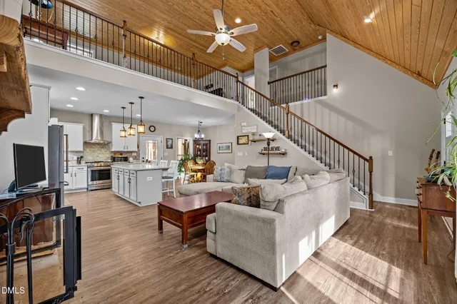 a living room with furniture and kitchen view