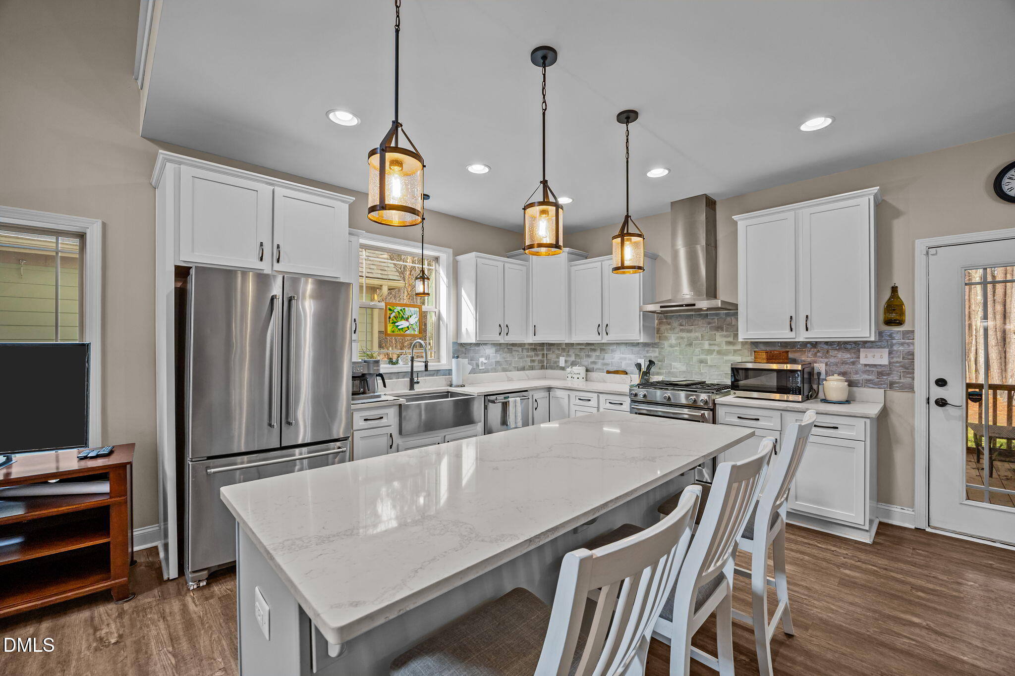 3225 Back Acres Road Efland, NC 27243 - Photo 8 of 57 a kitchen with stainless steel appliances granite countertop a refrigerator a stove a sink a dining table and chairs