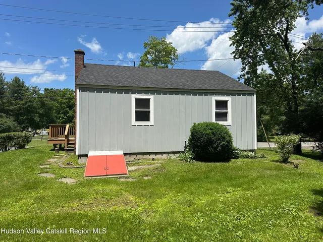 a backyard of a house with table and chairs