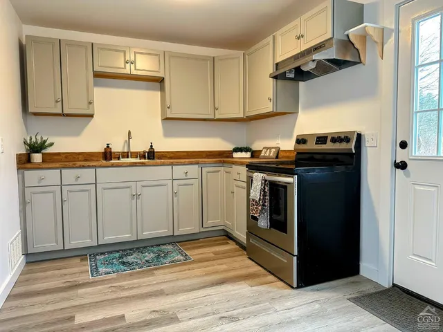 a kitchen with a stove top oven sink and cabinets