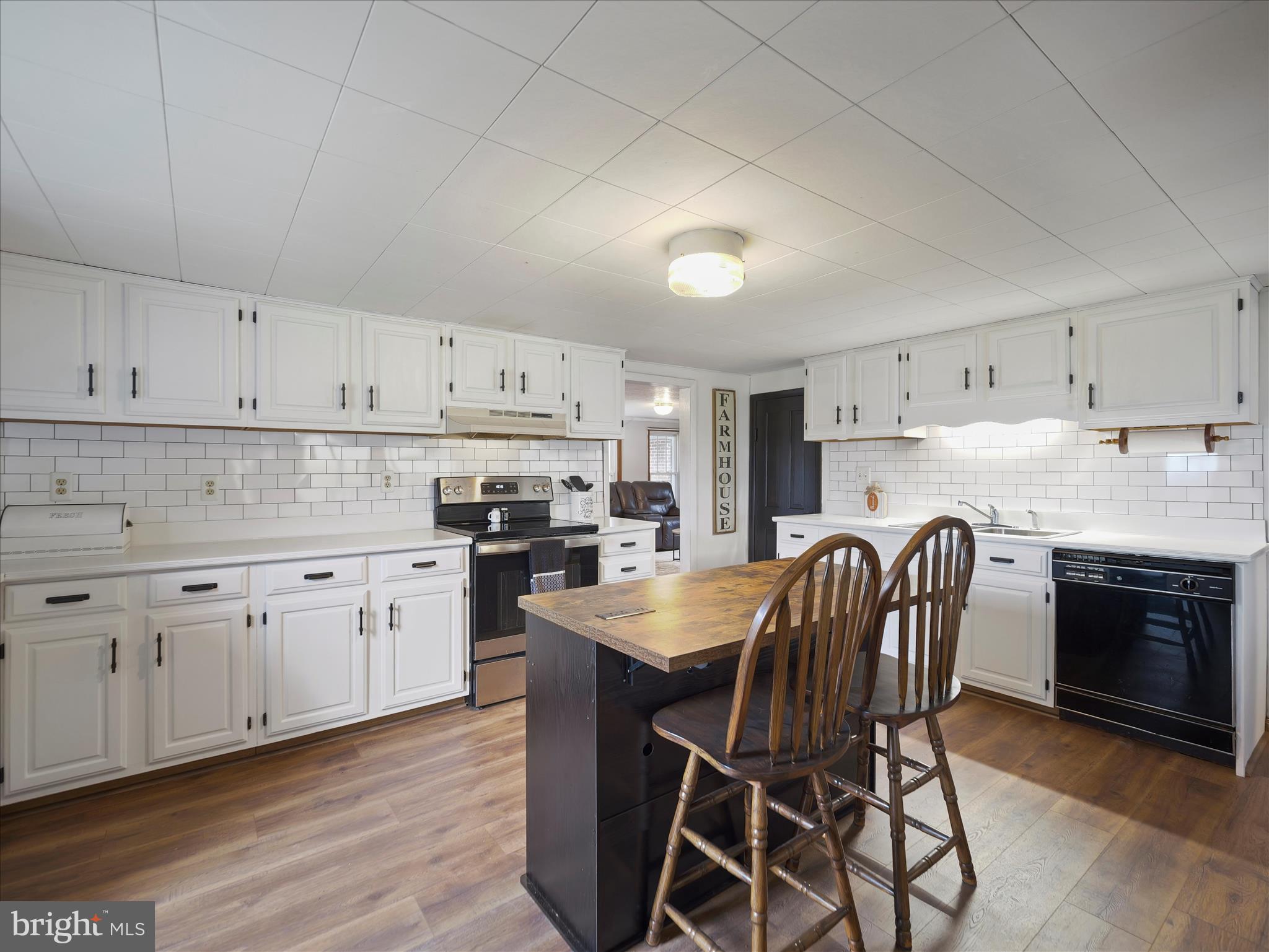 14628 Hollow Road Hancock, MD 21750 - Photo 16 of 54 a kitchen with stainless steel appliances granite countertop a white cabinets and wooden floor