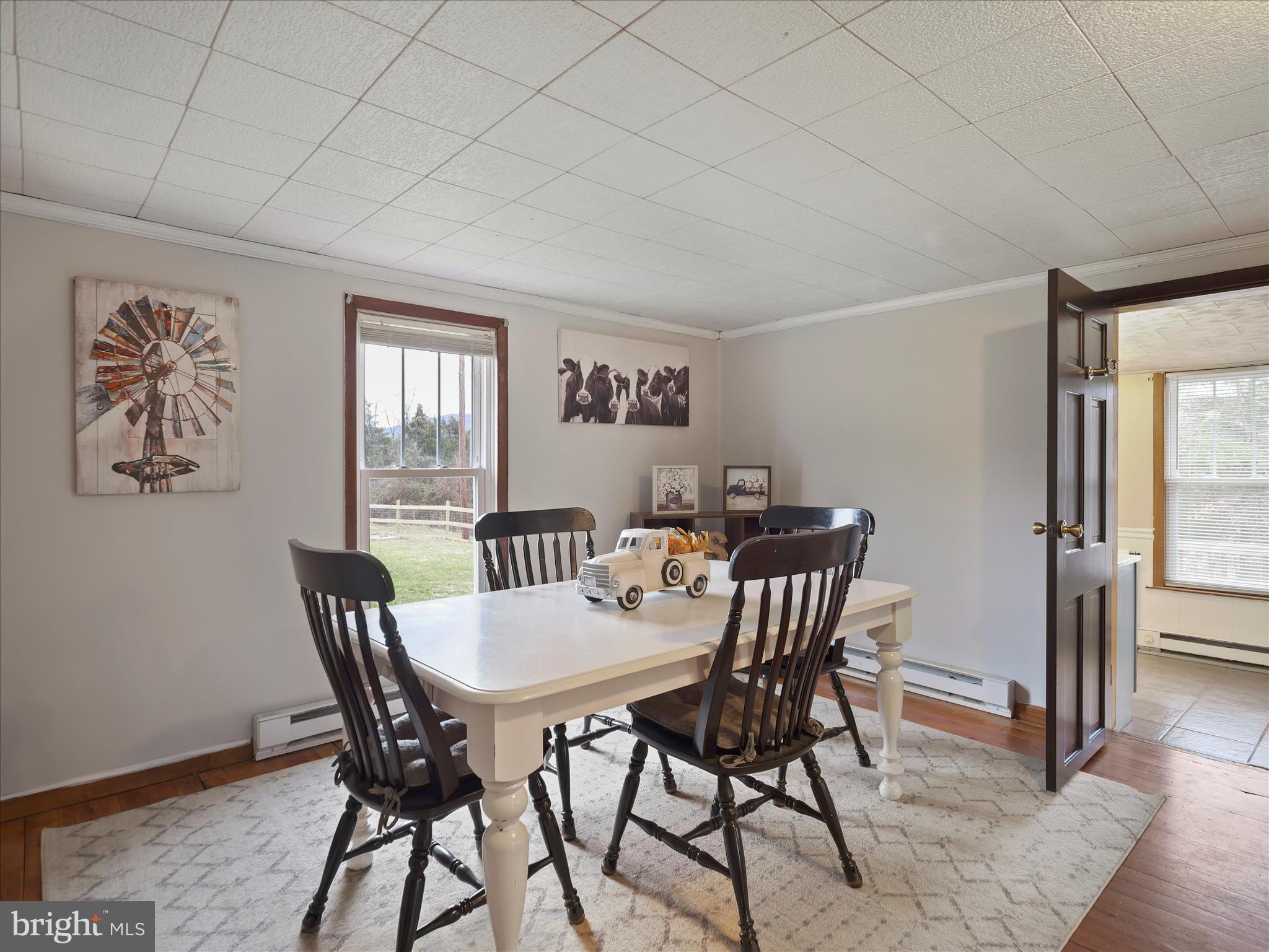 14628 Hollow Road Hancock, MD 21750 - Photo 17 of 54 a view of a dining room with furniture and wooden floor