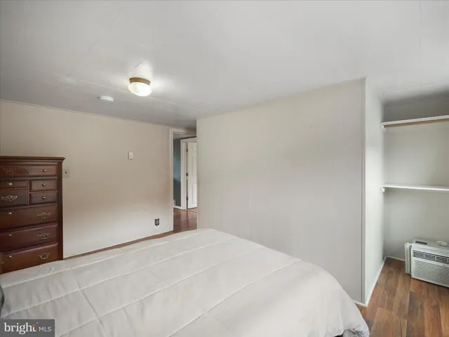 a bedroom with a bed and a tv on the dresser