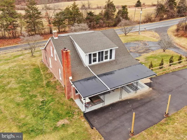 a front view of a house with sitting area