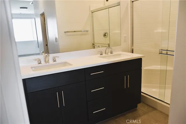 a bathroom with a double vanity sink and a mirror