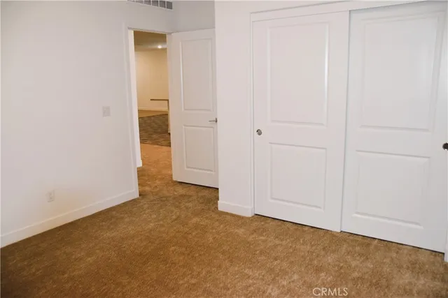 an empty room with closet area