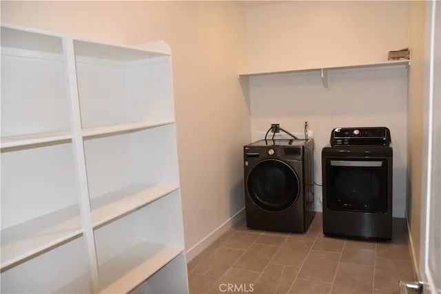 a utility room with sink dryer and washer