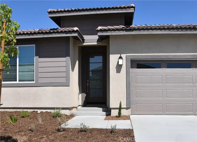 a side view of a house with a garage