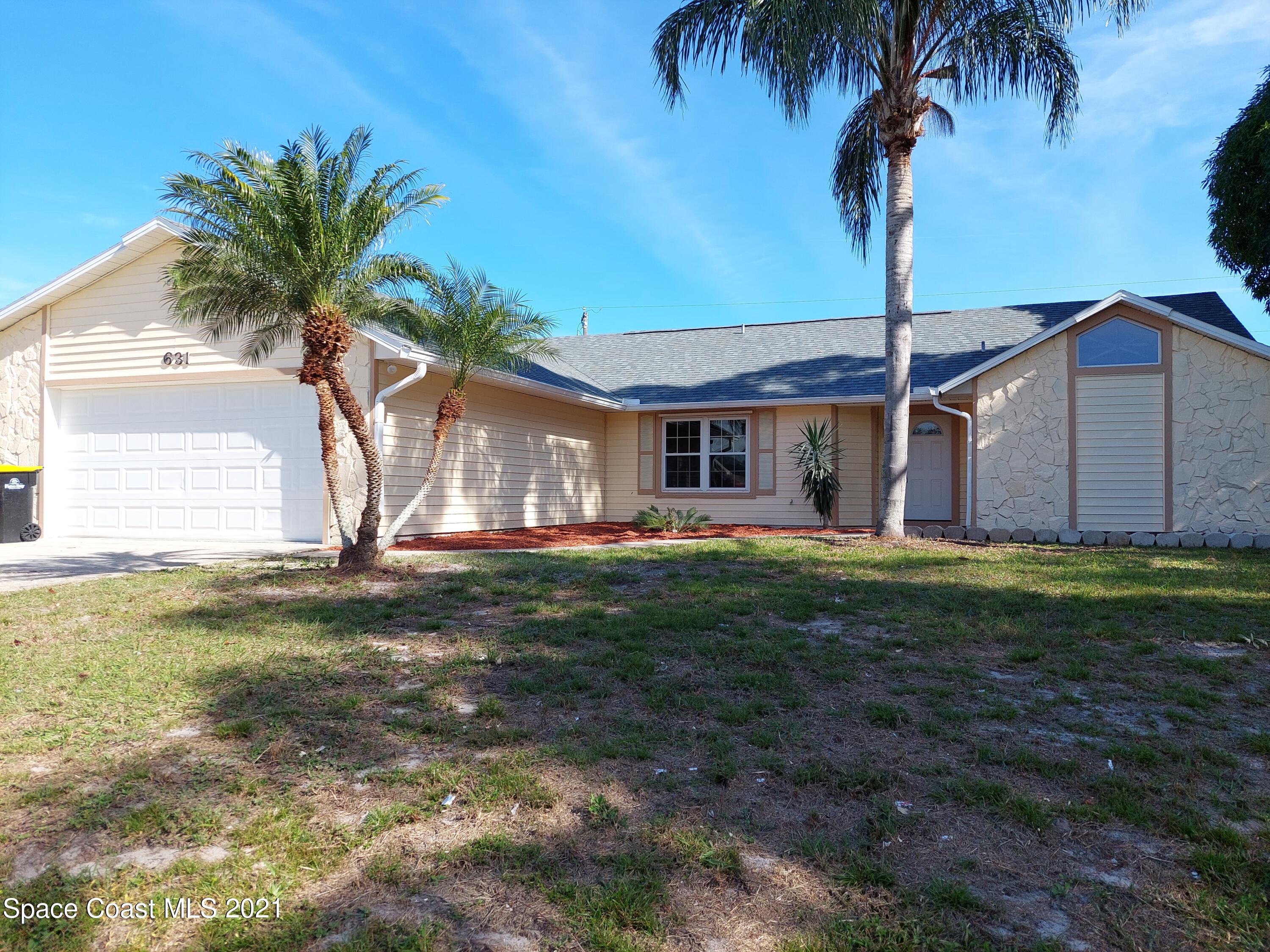 631 Furth Road Northwest Palm Bay, FL 32907 - Photo 1 of 42 a front view of house with yard and porch