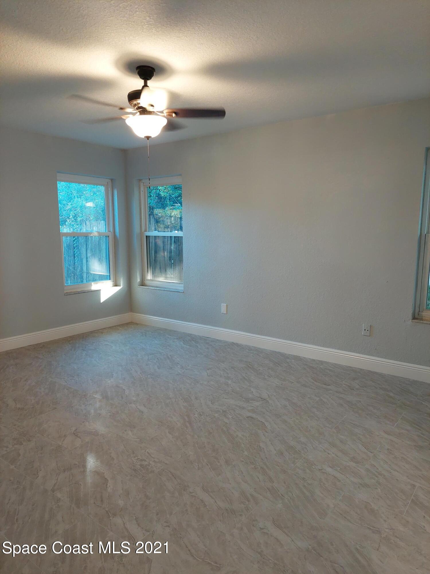631 Furth Road Northwest Palm Bay, FL 32907 - Photo 13 of 42 a view of an empty room with a chandelier fan