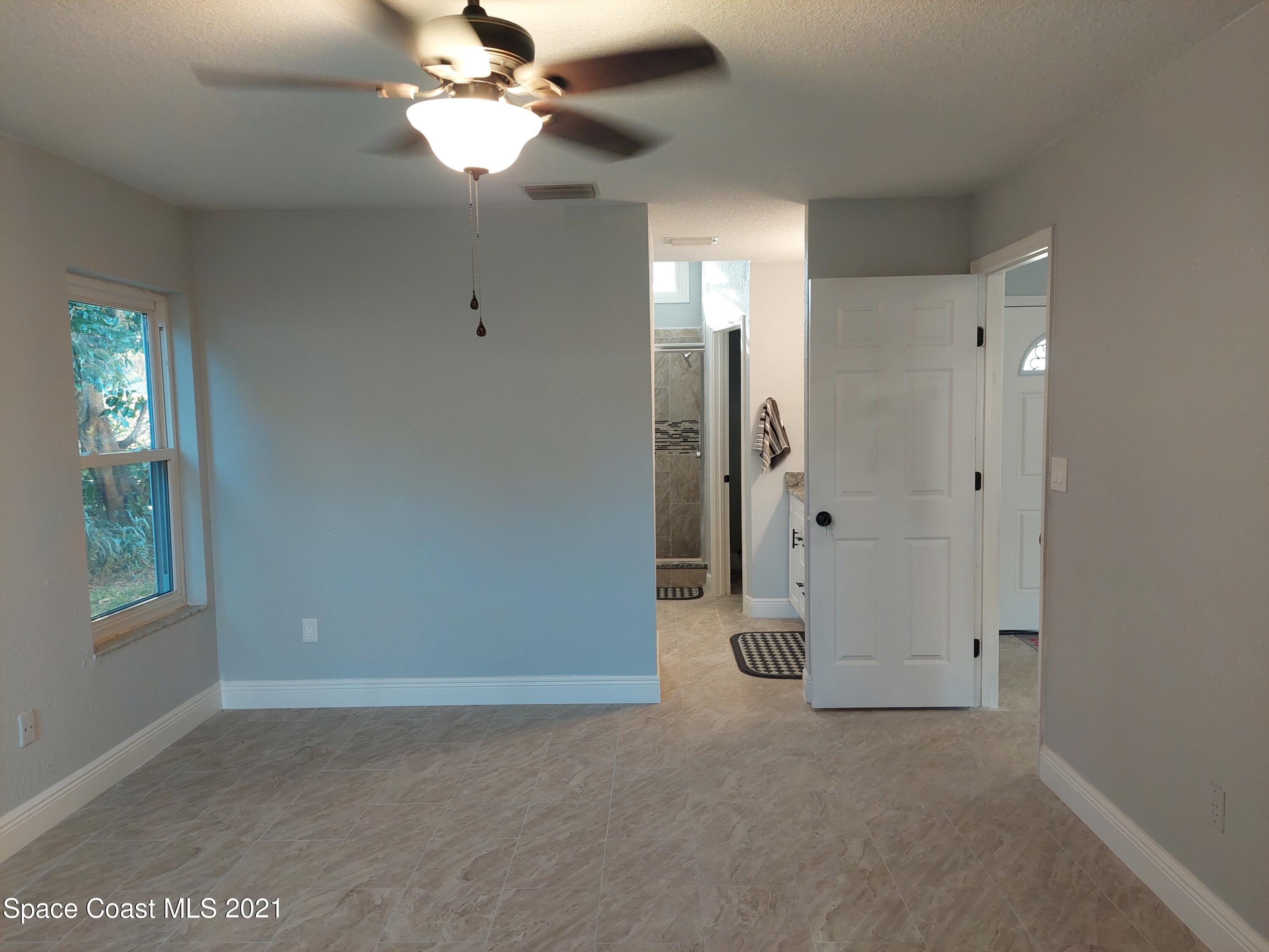 631 Furth Road Northwest Palm Bay, FL 32907 - Photo 14 of 42 wooden floor in an empty room with a window