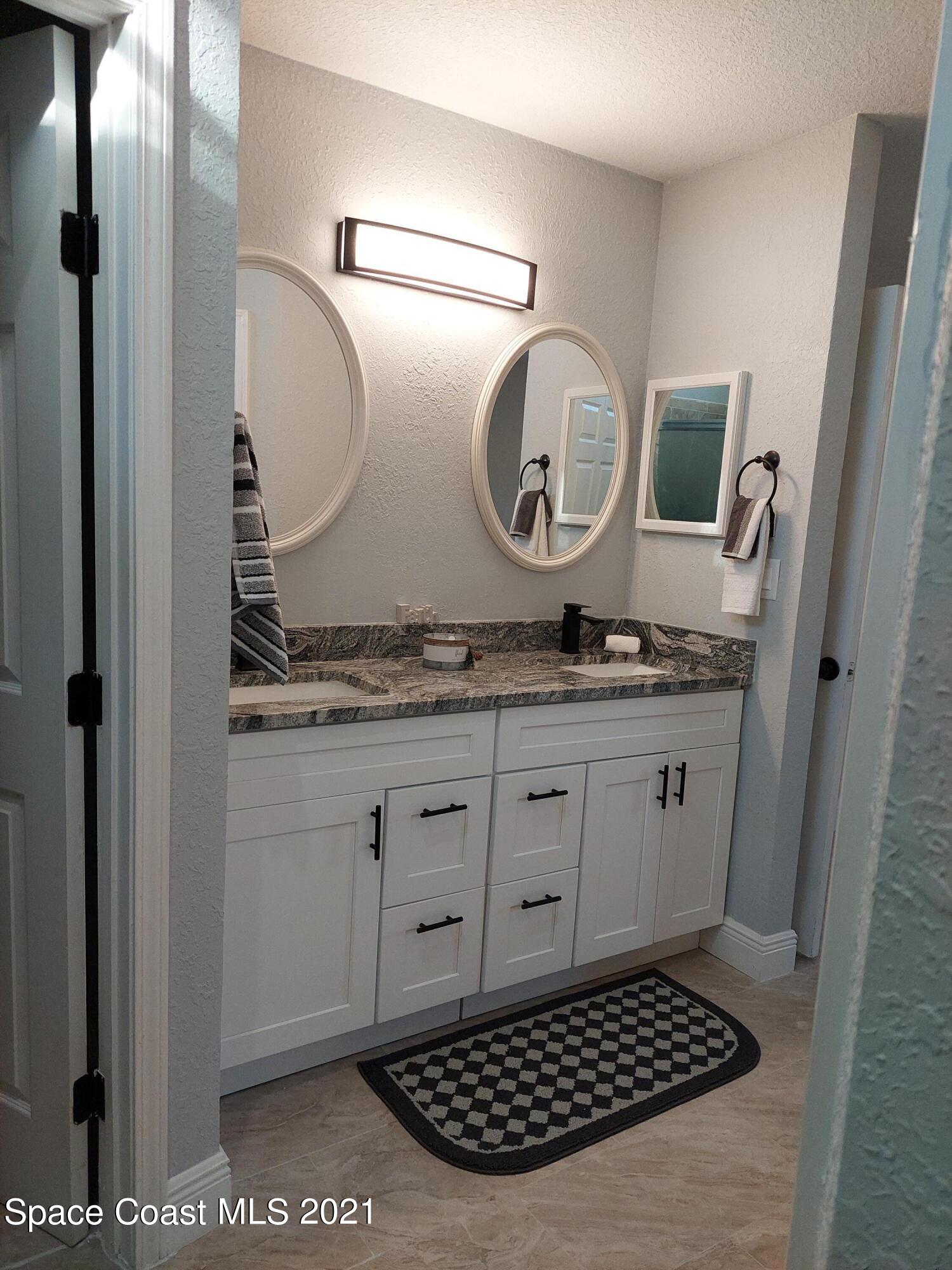 631 Furth Road Northwest Palm Bay, FL 32907 - Photo 15 of 42 a bathroom with a granite countertop sink and a mirror