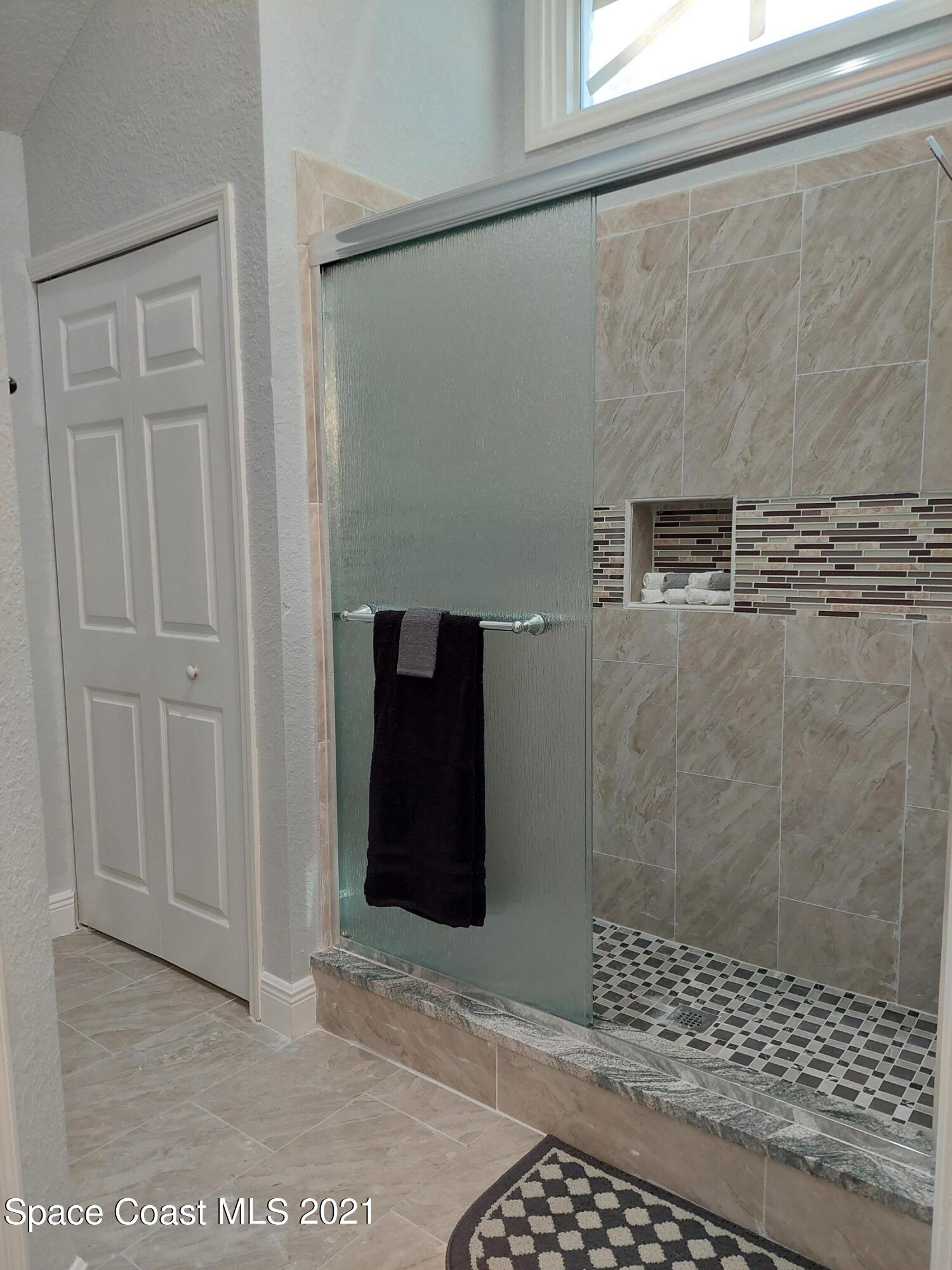 631 Furth Road Northwest Palm Bay, FL 32907 - Photo 17 of 42 a bathroom with a shower