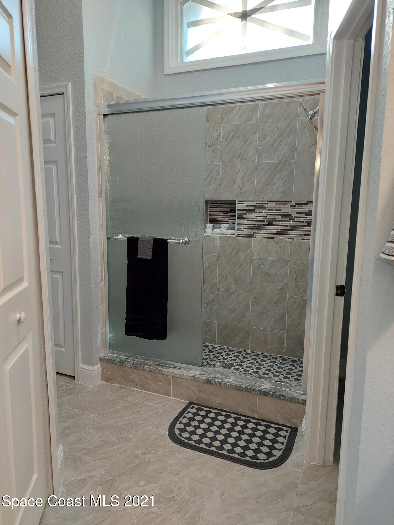 631 Furth Road Northwest Palm Bay, FL 32907 - Photo 18 of 42 a bathroom with a shower