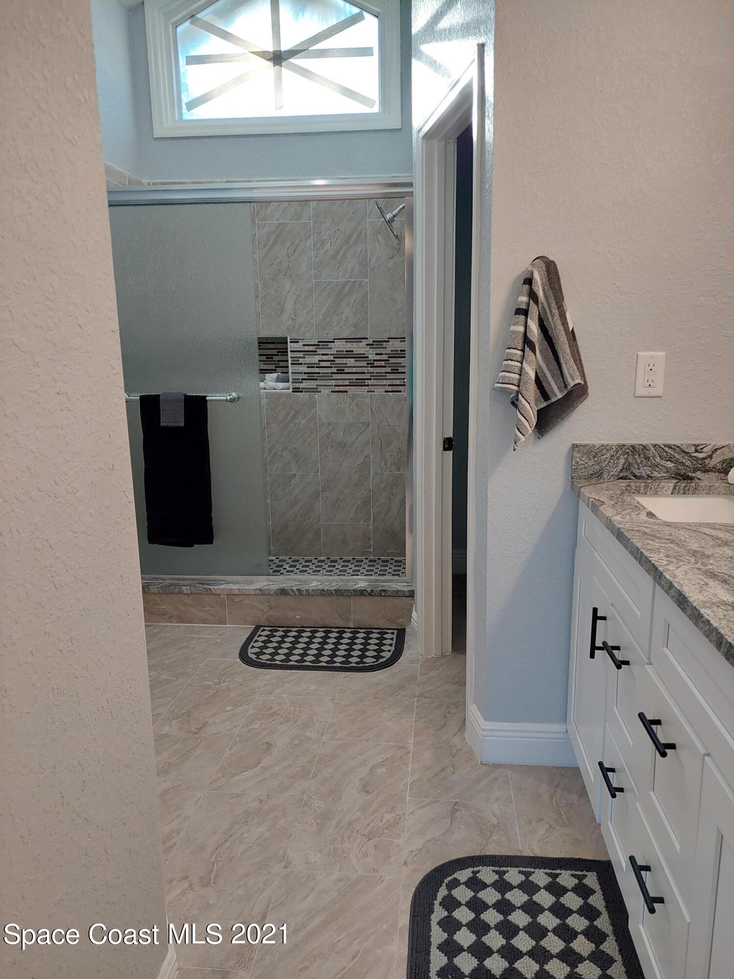631 Furth Road Northwest Palm Bay, FL 32907 - Photo 24 of 42 a bathroom with a shower and a sink