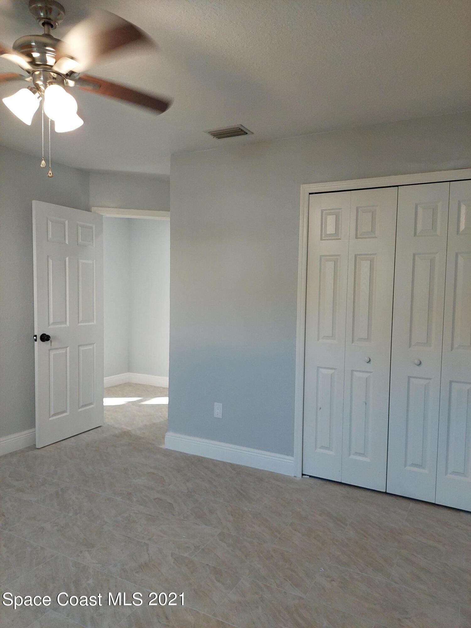 631 Furth Road Northwest Palm Bay, FL 32907 - Photo 28 of 42 a view of an empty room and chandelier fan