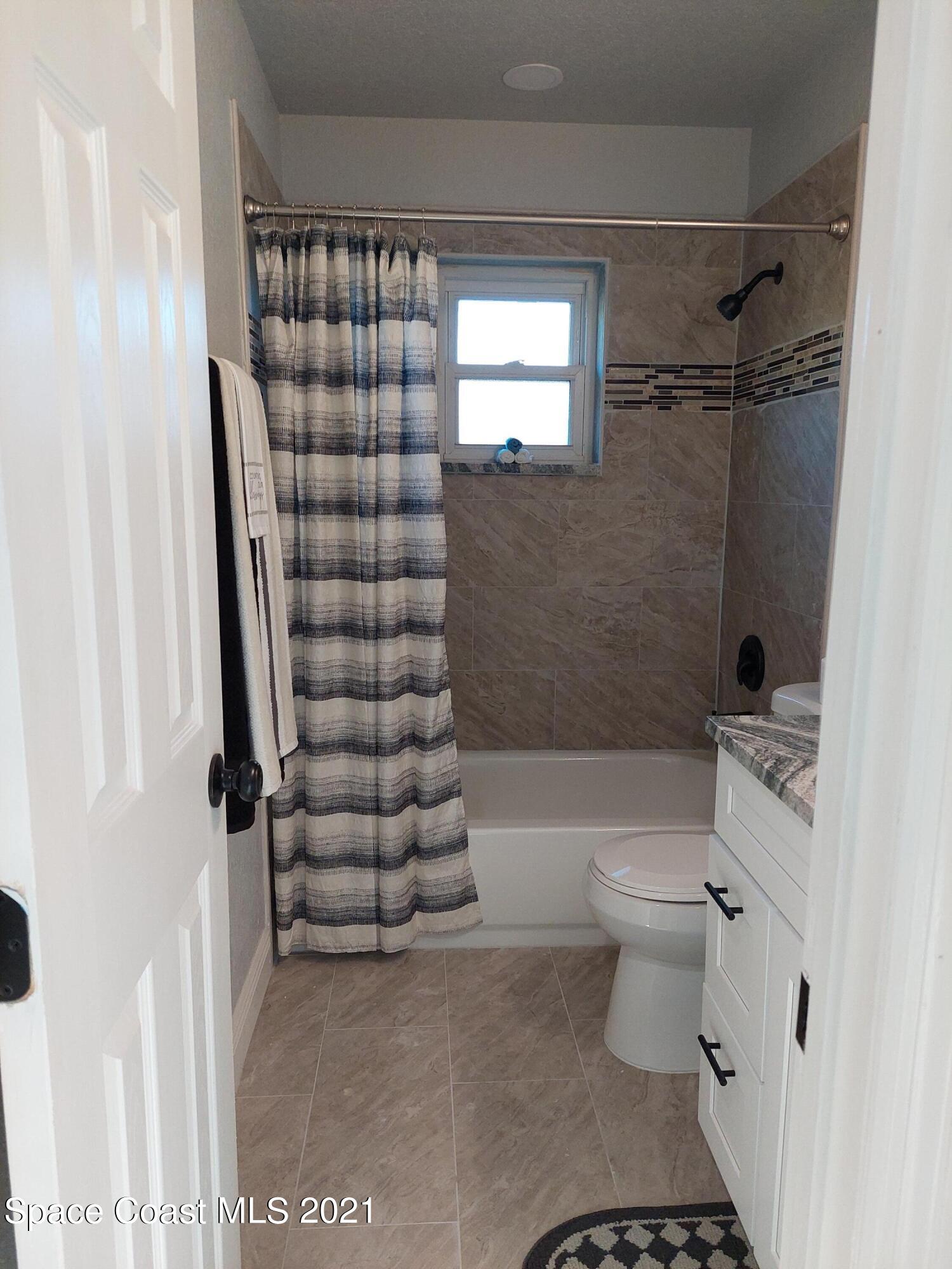 631 Furth Road Northwest Palm Bay, FL 32907 - Photo 30 of 42 a bathroom with a toilet a sink and shower