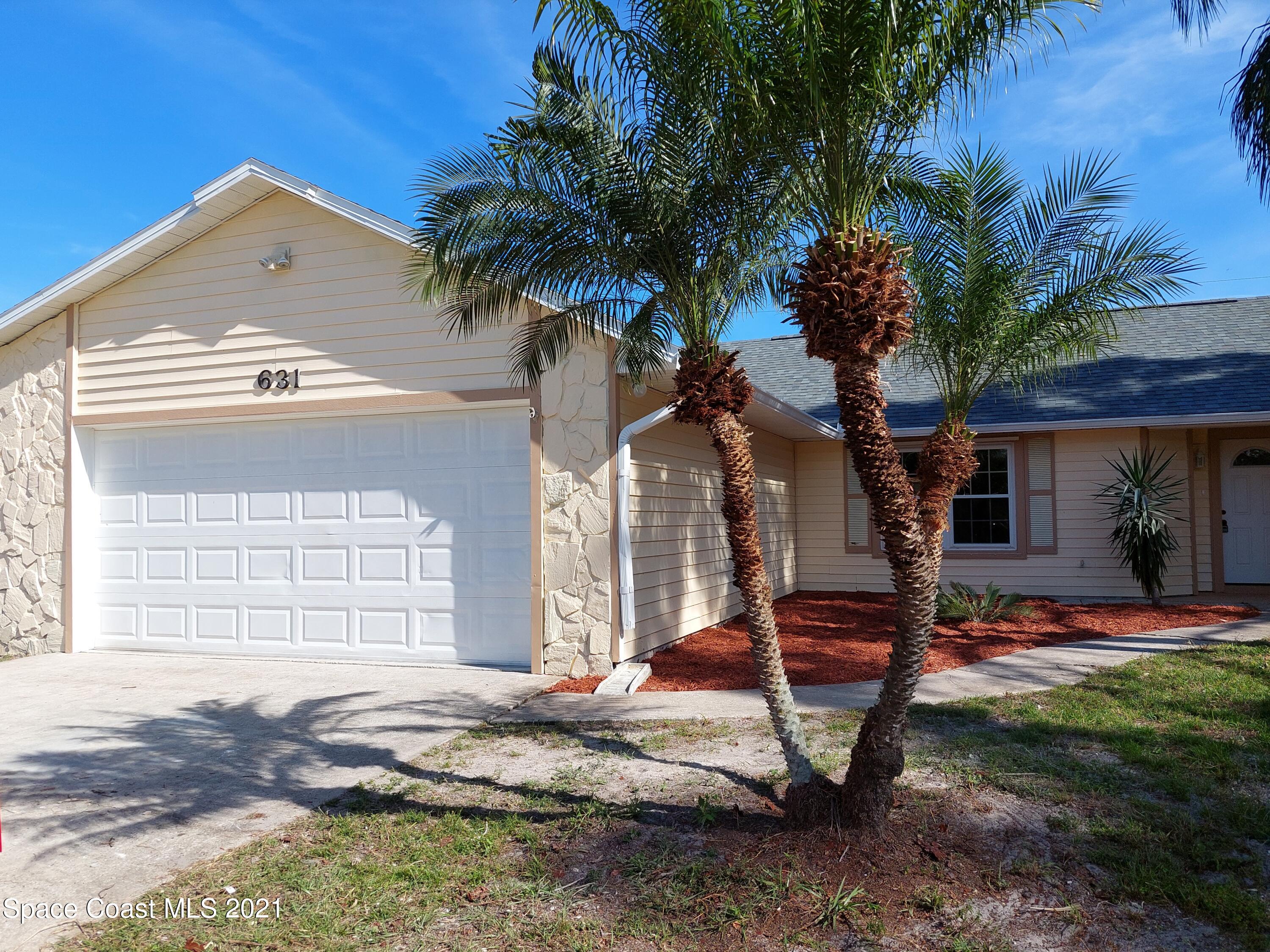 631 Furth Road Northwest Palm Bay, FL 32907 - Photo 4 of 42 a front view of a house with garden