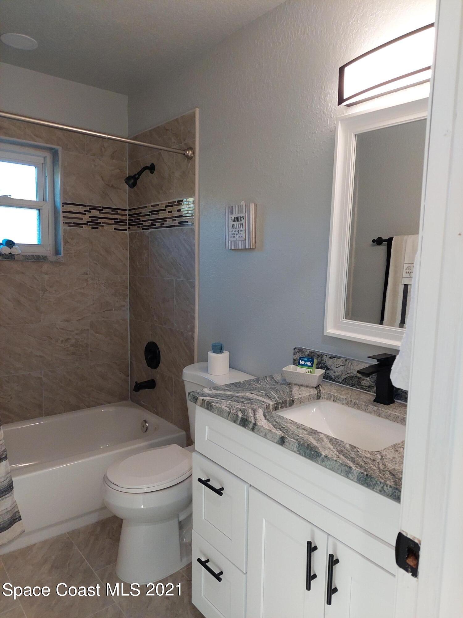 631 Furth Road Northwest Palm Bay, FL 32907 - Photo 33 of 42 a bathroom with a granite countertop sink toilet and shower