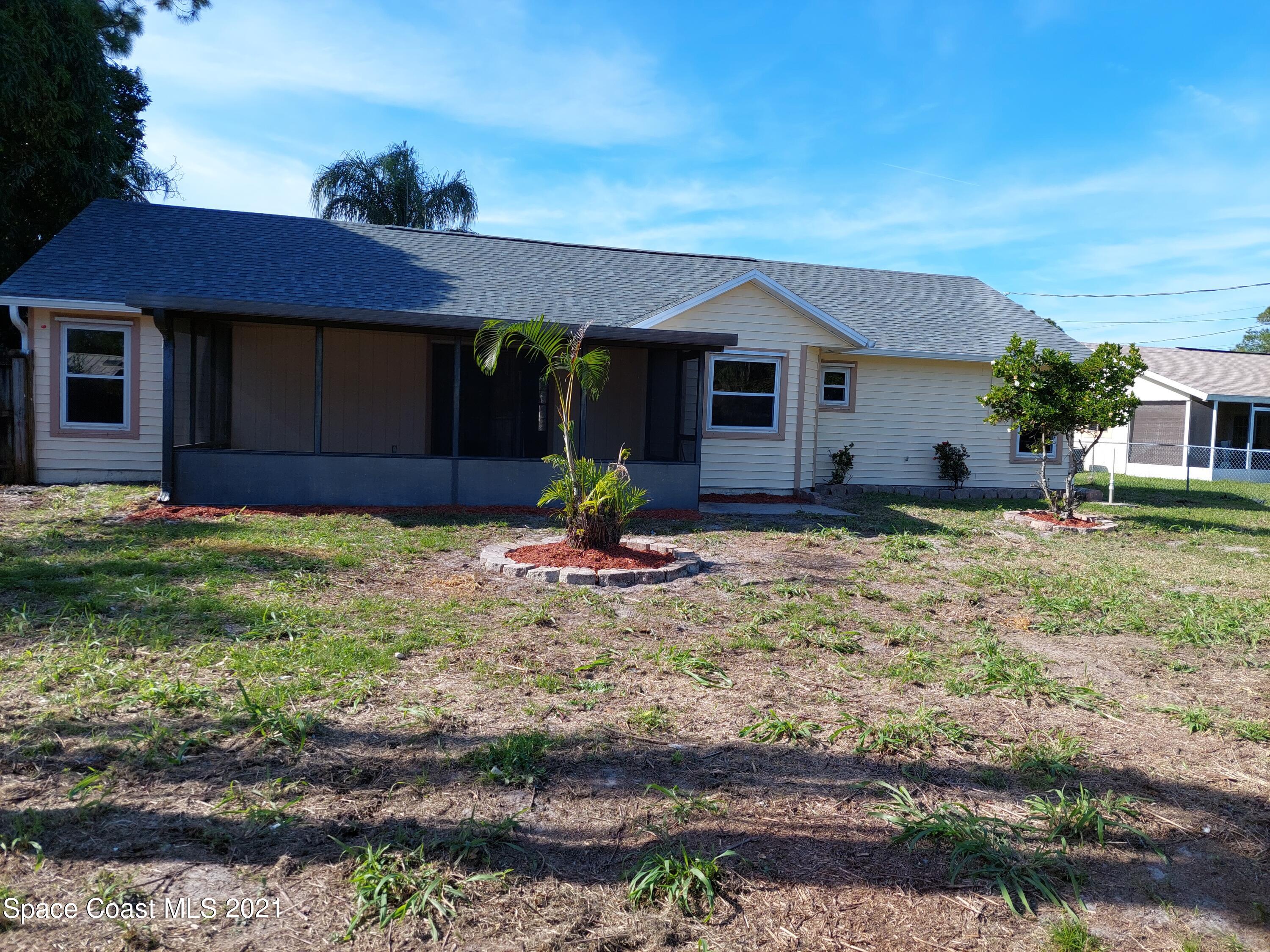631 Furth Road Northwest Palm Bay, FL 32907 - Photo 38 of 42 a front view of a house with a yard
