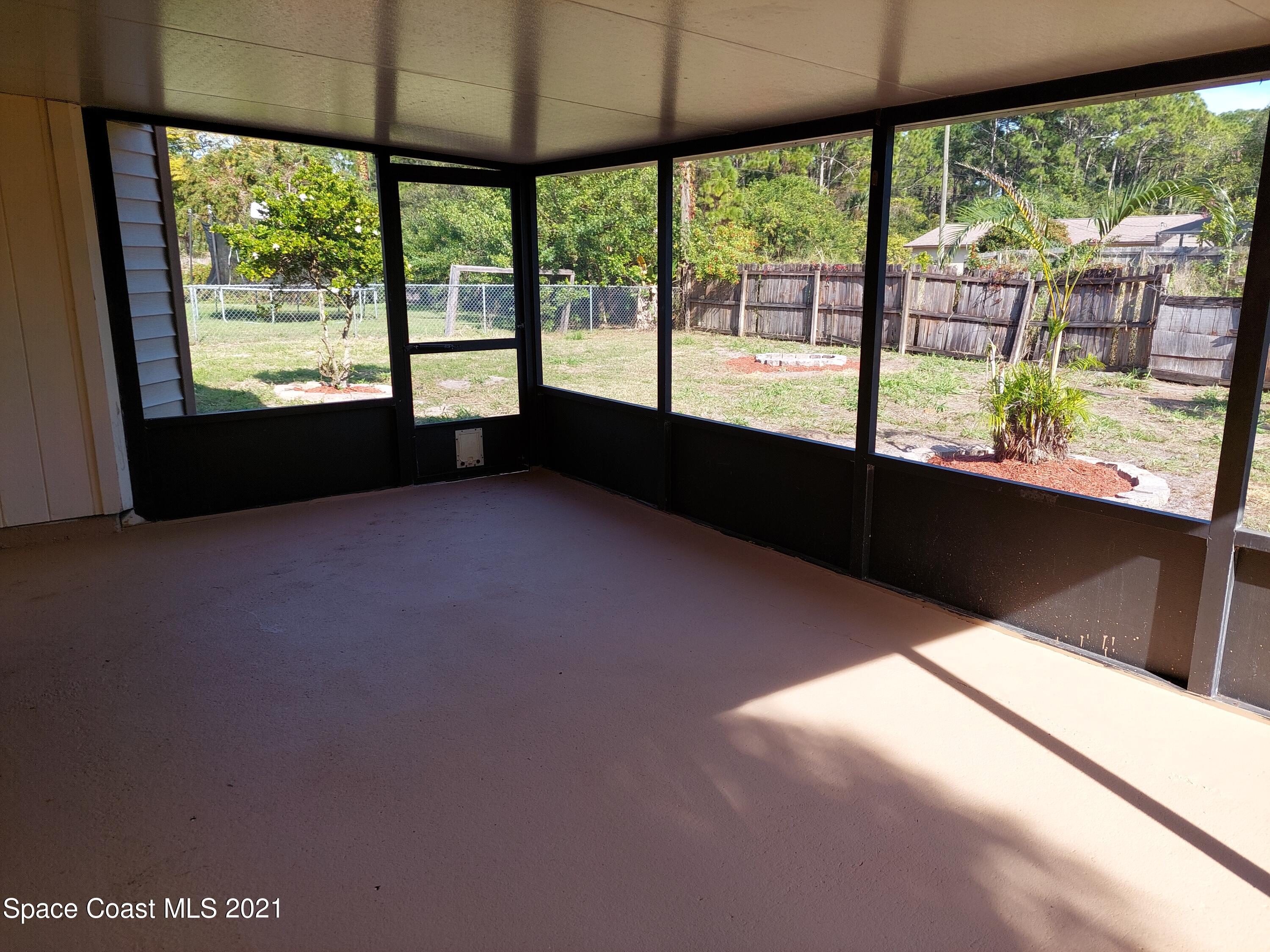 631 Furth Road Northwest Palm Bay, FL 32907 - Photo 40 of 42 a living room with large windows